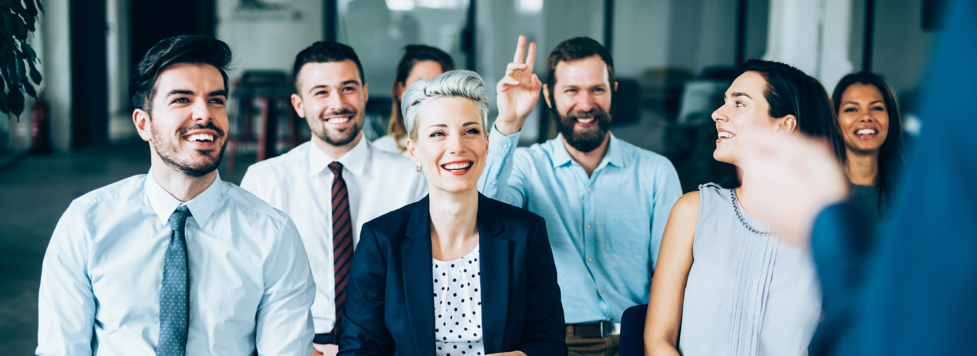 A diverse group of young professionals collaborating around a laptop in a modern office setting. Perfect for business or tech concepts.